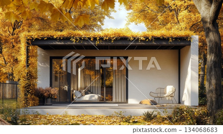 The cozy modern home is nestled within a forest, showcasing a stunning display of autumn leaves. The golden foliage frames the sleek architecture, enhancing the serene atmosphere of the environment. The cozy modern home is nestled within a forest, showcasing a stunning display of autumn leaves. The golden foliage frames the sleek architecture, enhancing the serene atmosphere of the environment. 134068683