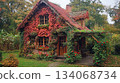 A quaint cottage is enveloped in colorful ivy and blooming flowers, creating a picturesque autumn landscape. The lush garden and peaceful surroundings enhance the tranquil atmosphere of the scene. A quaint cottage is enveloped in colorful ivy and blooming flowers, creating a picturesque autumn landscape. The lush garden and peaceful surroundings enhance the tranquil atmosphere of the scene. 134068734