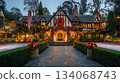 A large, two-story house with a brick exterior is elaborately decorated for Christmas. The house is adorned with lights, wreaths, and garlands, creating a festive ambiance. A large, two-story house with a brick exterior is elaborately decorated for Christmas. The house is adorned with lights, wreaths, and garlands, creating a festive ambiance. 134068743