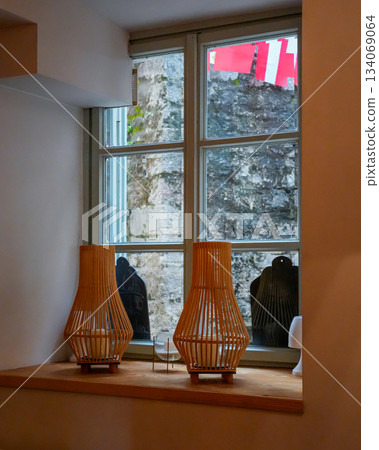 Photo of two wooden lamps placed on a window sill. The image highlights the natural texture of the wood and soft indoor lighting, suitable for interior design, home decor, and cozy living space Photo of two wooden lamps placed on a window sill. The image highlights the natural texture of the wood and soft indoor lighting, suitable for interior design, home decor, and cozy living space 134069064