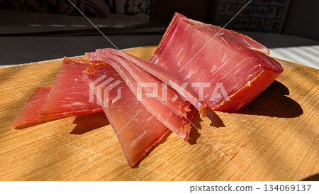 Market stall showcasing thinly sliced prosciutto for tasting Market stall showcasing thinly sliced prosciutto for tasting 134069137