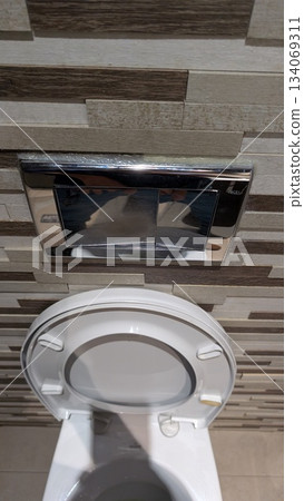 Clean restroom interior showcasing plumbing and hygiene features 134069311