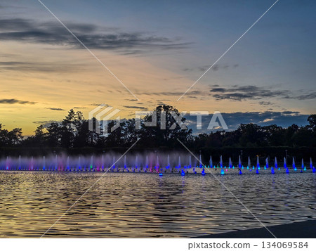 Sunset Serenity Fountain Silhouette Against Golden Sky 134069584