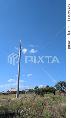 rural connection motif, power line stretching across peaceful countryside under bright sky 134069585