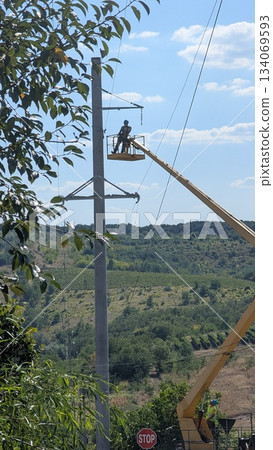 maintenance technician conducts safety inspection on overhead electrical lines in open environment maintenance technician conducts safety inspection on overhead electrical lines in open environment 134069593