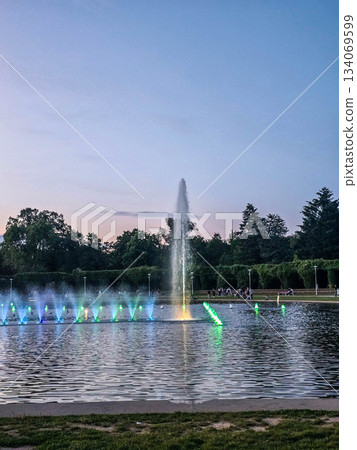 Sunset Serenity Fountain Silhouette Against Golden Sky Sunset Serenity Fountain Silhouette Against Golden Sky 134069599