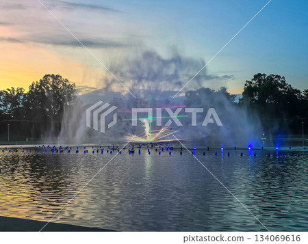Sunset Serenity Fountain Silhouette Against Golden Sky Sunset Serenity Fountain Silhouette Against Golden Sky 134069616