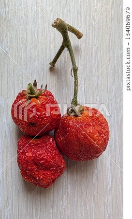 vintage pantry scene with tomatoes, dried cherry tomatoes resting on textured surface evoke memories 134069679