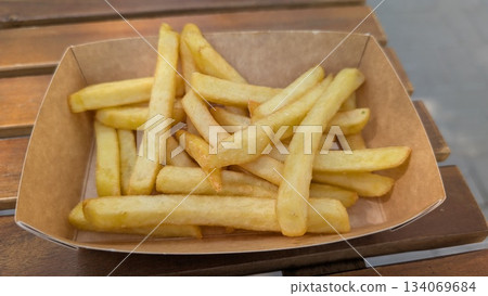 Freshly prepared golden fries in rustic outdoor cafe setting Freshly prepared golden fries in rustic outdoor cafe setting 134069684
