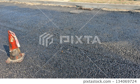 New road surface, Freshly laid roadway with safety cones present New road surface, Freshly laid roadway with safety cones present 134069724