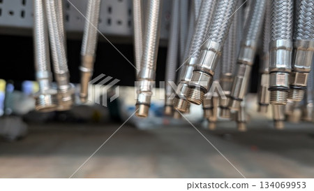 A Detailed CloseUp of Silver Metal Hoses Complete with Their Connectors and Fittings 134069953