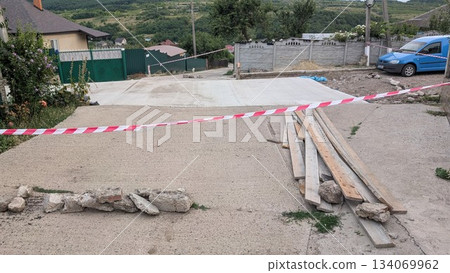 Caution in Road Construction Area marked with tape and wood planks for your safety 134069962