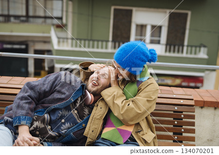 Laughter and playful antics on vibrant street environment 134070201