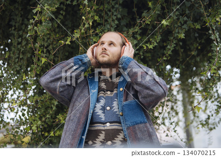 Person experiencing tranquil soundscape beneath leafy canopy Person experiencing tranquil soundscape beneath leafy canopy 134070215