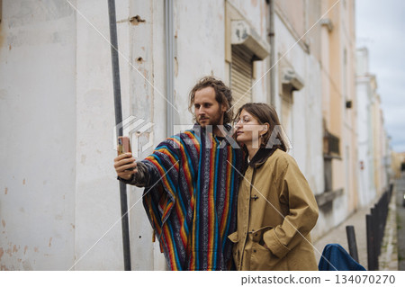 Two individuals seeking directions through colorful urban alleyways 134070270