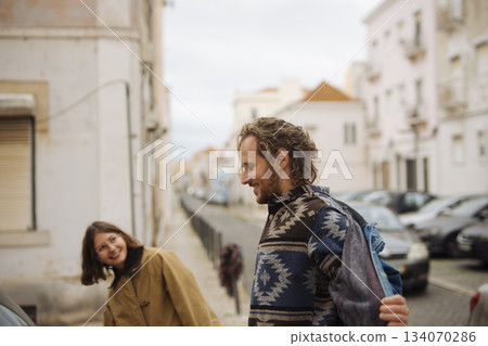 Pair strolling contentedly, Lovers meander through charming walkway Pair strolling contentedly, Lovers meander through charming walkway 134070286