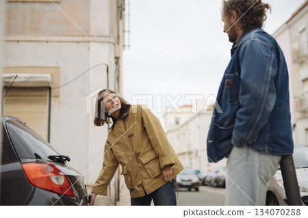 Individual examines traditional entrance amid cityscape 134070288