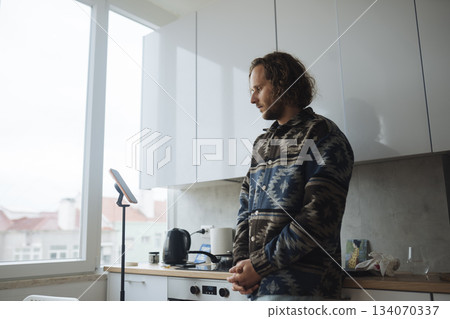 Individual examines culinary content while dressed comfortably at home Individual examines culinary content while dressed comfortably at home 134070337