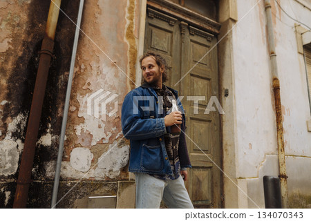 Portrait of individual wearing layered knitwear on city street 134070343