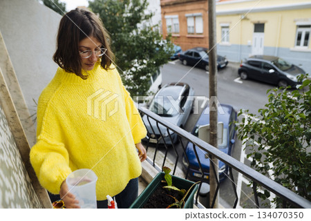 caucasian woman plant blogger creating balcony content 134070350