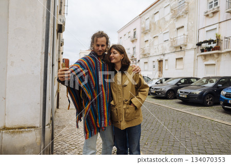Loving partners enjoying serene walk through historic district hand in hand 134070353