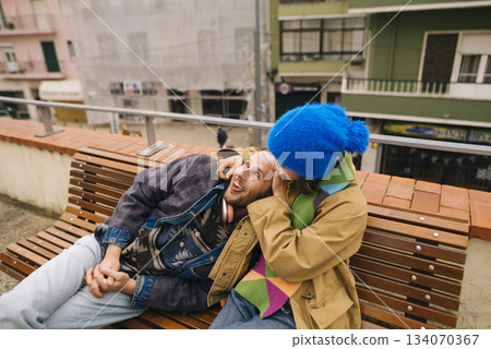 Intimate couple enjoying lively city atmosphere together Intimate couple enjoying lively city atmosphere together 134070367