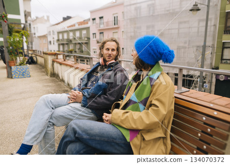 Individuals comfortably conversing along pastelcolored riverside walkway 134070372