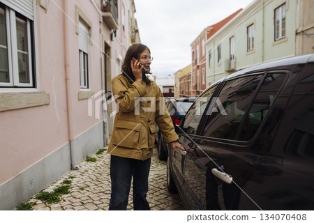 Casual female pedestrian gestures while speaking down narrow roadway Casual female pedestrian gestures while speaking down narrow roadway 134070408