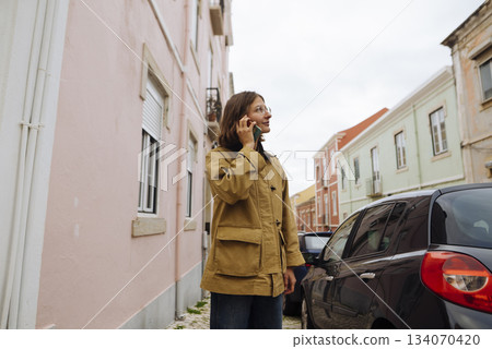 Businesswoman organizing site tour amidst city environment under cloudy sky Businesswoman organizing site tour amidst city environment under cloudy sky 134070420