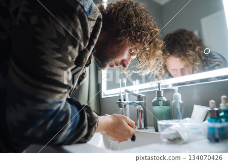 Colorful artist wipes away paint and dirt after busy session 134070426