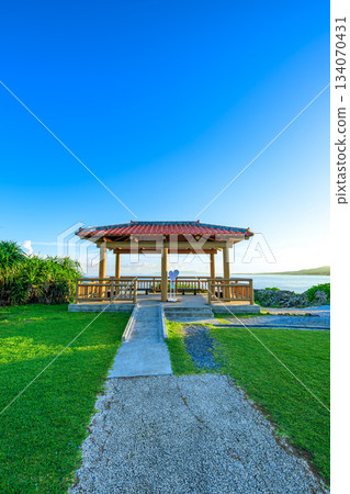 A beautiful view of the sea at Cape Maeda, with a red-tiled roof gazebo and blue sky A beautiful view of the sea at Cape Maeda, with a red-tiled roof gazebo and blue sky 134070431