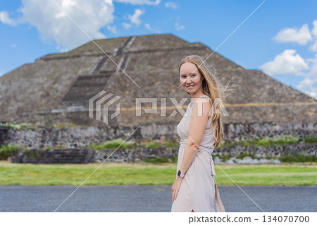 Female tourist standing in front of Teotihuacan pyramids in Mexico, enjoying sightseeing, adventure, and cultural heritage. Travel, tourism, and exploration concept 134070700