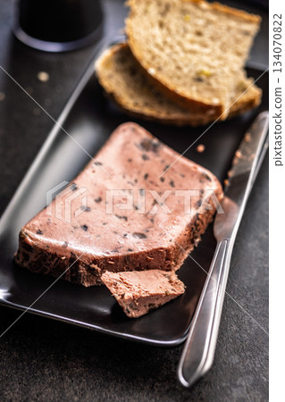 Liver pate with cranberries on black plate. Liver pate with cranberries on black plate. 134070822