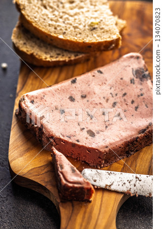 Liver pate with cranberries on wooden cutting board. Liver pate with cranberries on wooden cutting board. 134070823