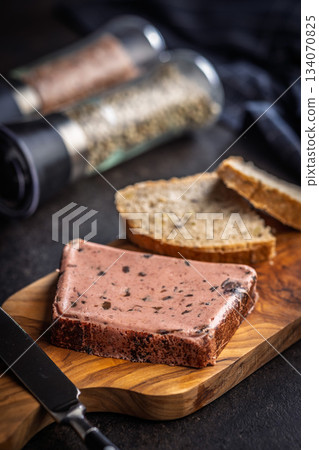 Liver pate with cranberries on wooden cutting board. Liver pate with cranberries on wooden cutting board. 134070825