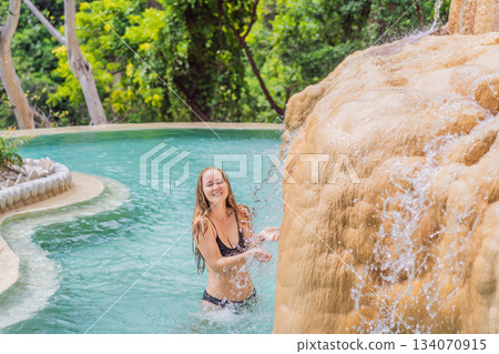 Female tourist exploring Grutas Tolantongo in Mexico, enjoying natural hot springs, scenic caves, and outdoor adventure. Travel, wellness, and sightseeing concept 134070915