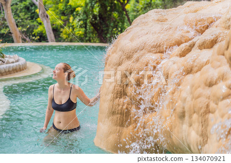 Female tourist exploring Grutas Tolantongo in Mexico, enjoying natural hot springs, scenic caves, and outdoor adventure. Travel, wellness, and sightseeing concept 134070921