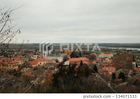 Historic rooftops of Sremski Karlovci with iconic yellow architecture and church towers. The scene conveys heritage, culture, and timeless atmosphere Historic rooftops of Sremski Karlovci with iconic yellow architecture and church towers. The scene conveys heritage, culture, and timeless atmosphere 134071533