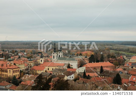 Historic rooftops of Sremski Karlovci with iconic yellow architecture and church towers. The scene conveys heritage, culture, and timeless atmosphere Historic rooftops of Sremski Karlovci with iconic yellow architecture and church towers. The scene conveys heritage, culture, and timeless atmosphere 134071538