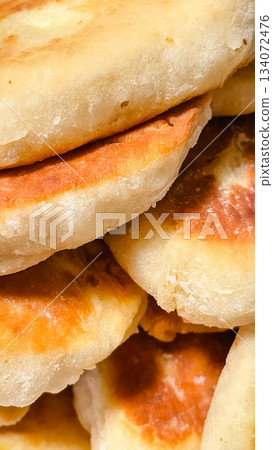 Close up of a pile of traditional homemade golden brown baked or fried pies Close up of a pile of traditional homemade golden brown baked or fried pies 134072476