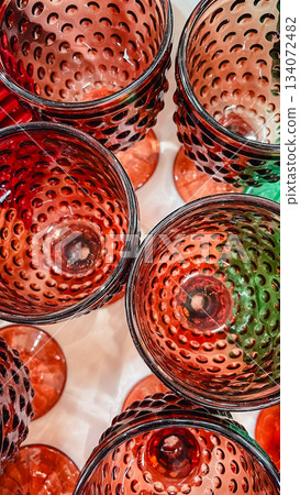 Close up overhead view of vibrant red glass goblets with a textured dimpled pattern Close up overhead view of vibrant red glass goblets with a textured dimpled pattern 134072482