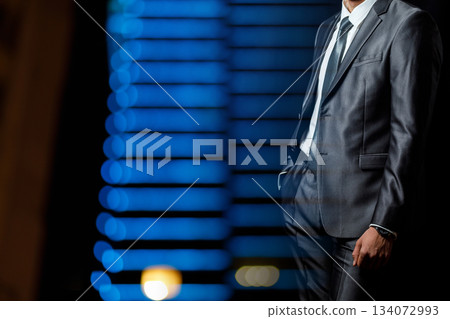 Man poses by blue lights. 134072993