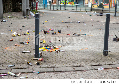 Fireworks rocket launcher box trash remains on german city street after Silvester party traditional celebration. Spoiled firecrackers waste rubbish european Germany town sidewalk Christmas New year 134073148