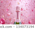Festive background with Christmas and New Year. Bottle of champagne and sparkles pink background. Celebration banner concept. 134073194
