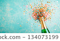 Festive background Christmas and New Year celebration. One bottle of champagne minimalist and sparkles gold glitter green bokeh background. Festive banner concept. 134073199