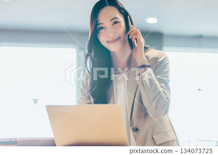 Business woman with a laptop computer in the office 134073725