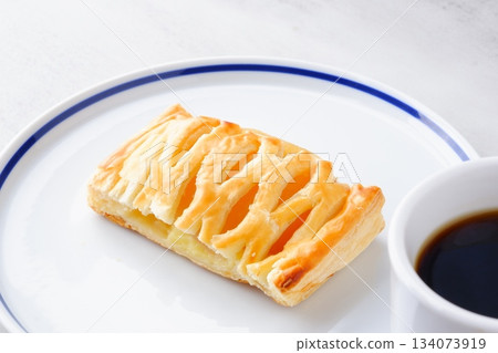 Apple Danish and Coffee - Enjoy a coffee break with apple pie filled with stewed apples and freshly brewed coffee Apple Danish and Coffee - Enjoy a coffee break with apple pie filled with stewed apples and freshly brewed coffee 134073919