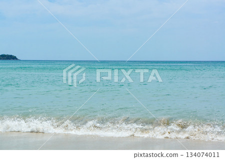 View of the waves crashing on the shore from the sandy beach View of the waves crashing on the shore from the sandy beach 134074011