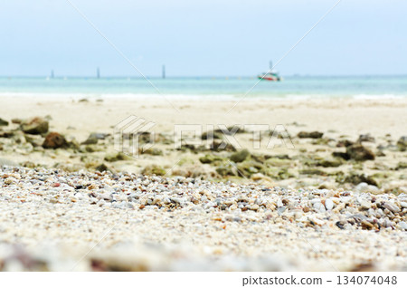 A beach scene in Thailand with lots of large pebbles 134074048