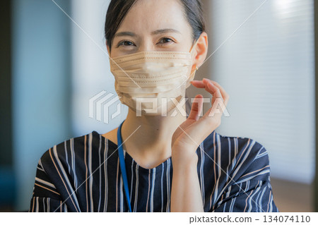A woman wearing a mask A woman wearing a mask 134074110